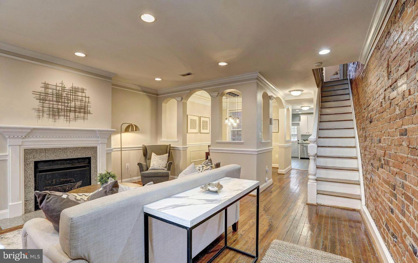 1237 I Street Northeast Washington, DC 20002 - Photo 3 of 27 a living room with furniture a fireplace and wooden floor