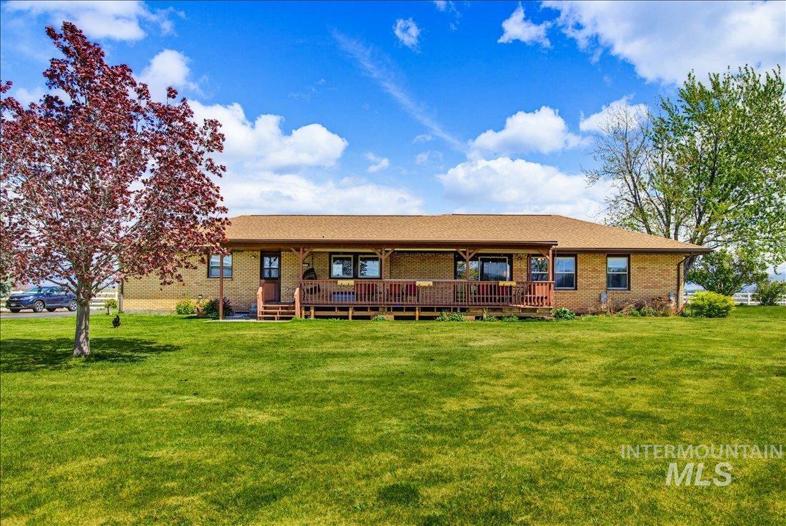 1901 South Ten Mile Road Meridian, ID 83642 - Photo 27 of 32 Ranch-style residence featuring a brick exterior and a covered front porch with a wooden deck