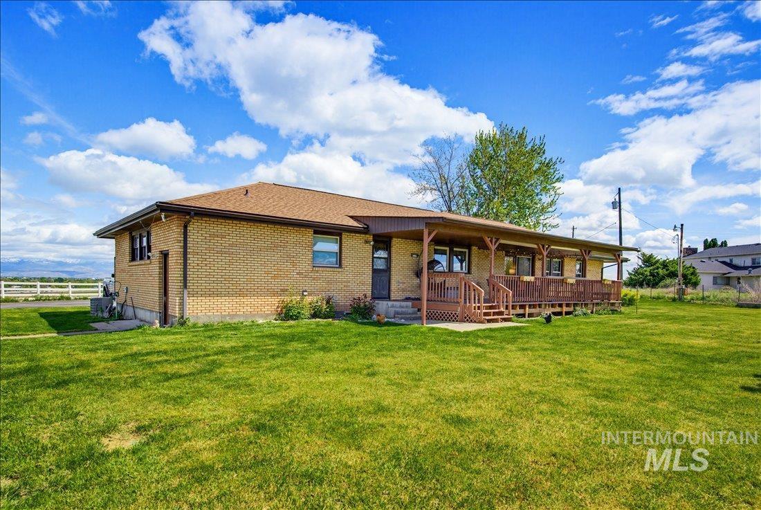 1901 South Ten Mile Road Meridian, ID 83642 - Photo 28 of 32 Brick exterior with a brown shingle roof and a spacious, covered wood deck