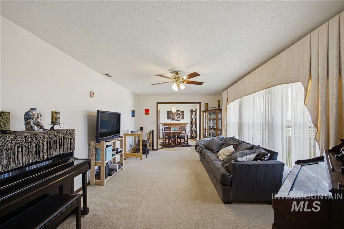 1901 South Ten Mile Road Meridian, ID 83642 - Photo 6 of 32 Spacious living area featuring neutral carpeting and a ceiling fan