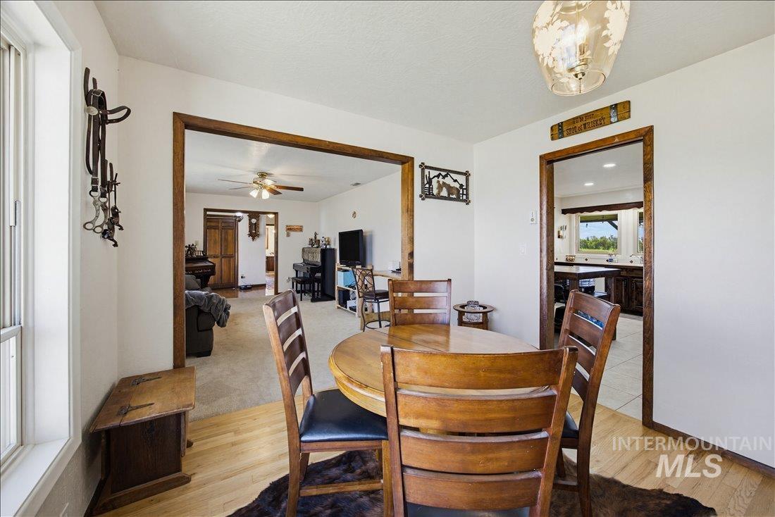 1901 South Ten Mile Road Meridian, ID 83642 - Photo 9 of 32 Dining area featuring hardwood flooring, white walls, and wood-trimmed doorways