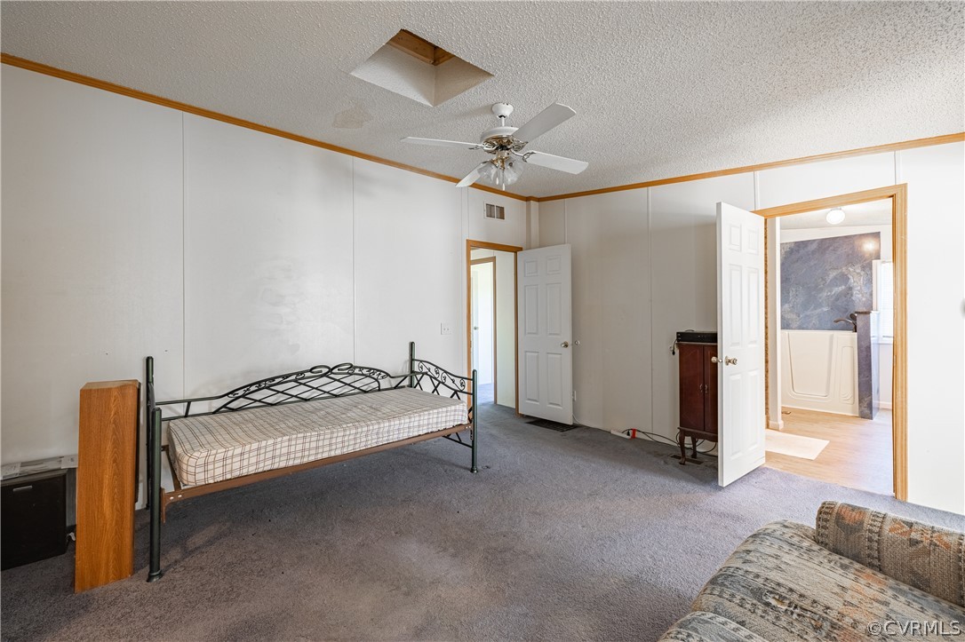 382 Fairview Road Blackstone, VA 23824 - Photo 21 of 32 a spacious bedroom with a bed and a chandelier