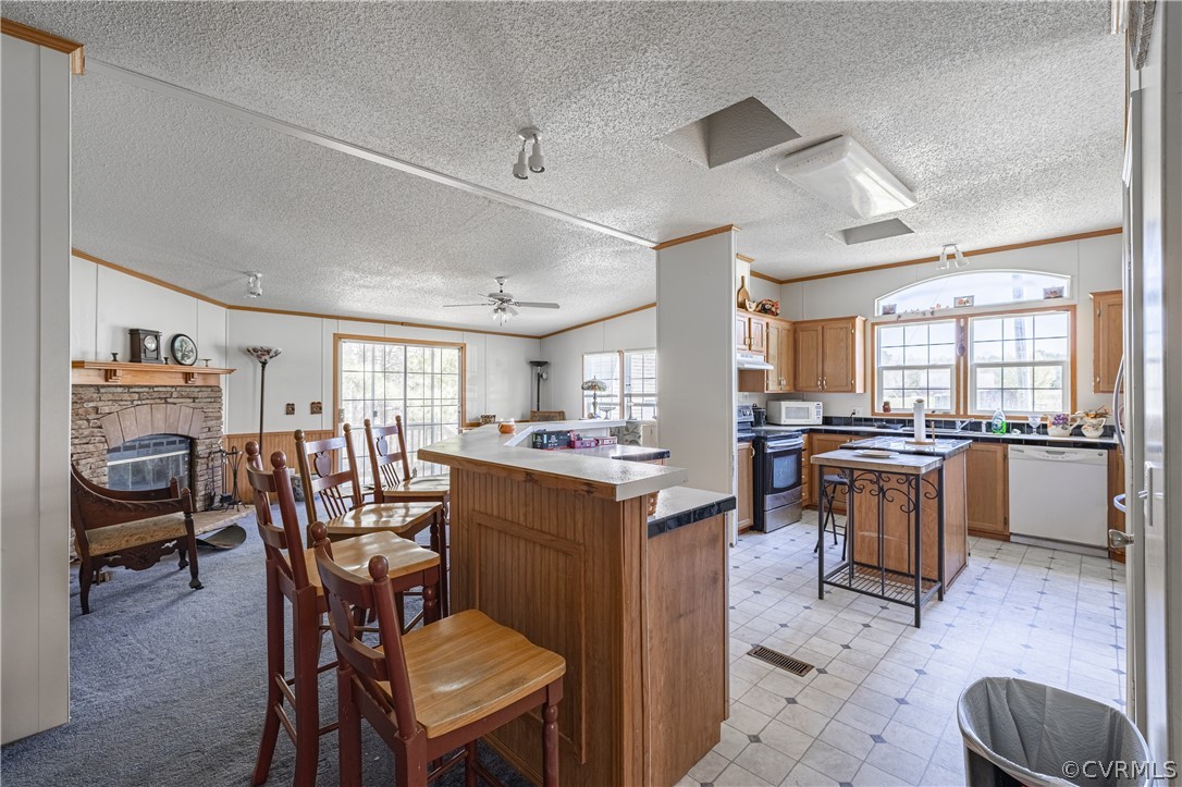 382 Fairview Road Blackstone, VA 23824 - Photo 9 of 32 a kitchen with a table chairs wooden cabinets and appliances
