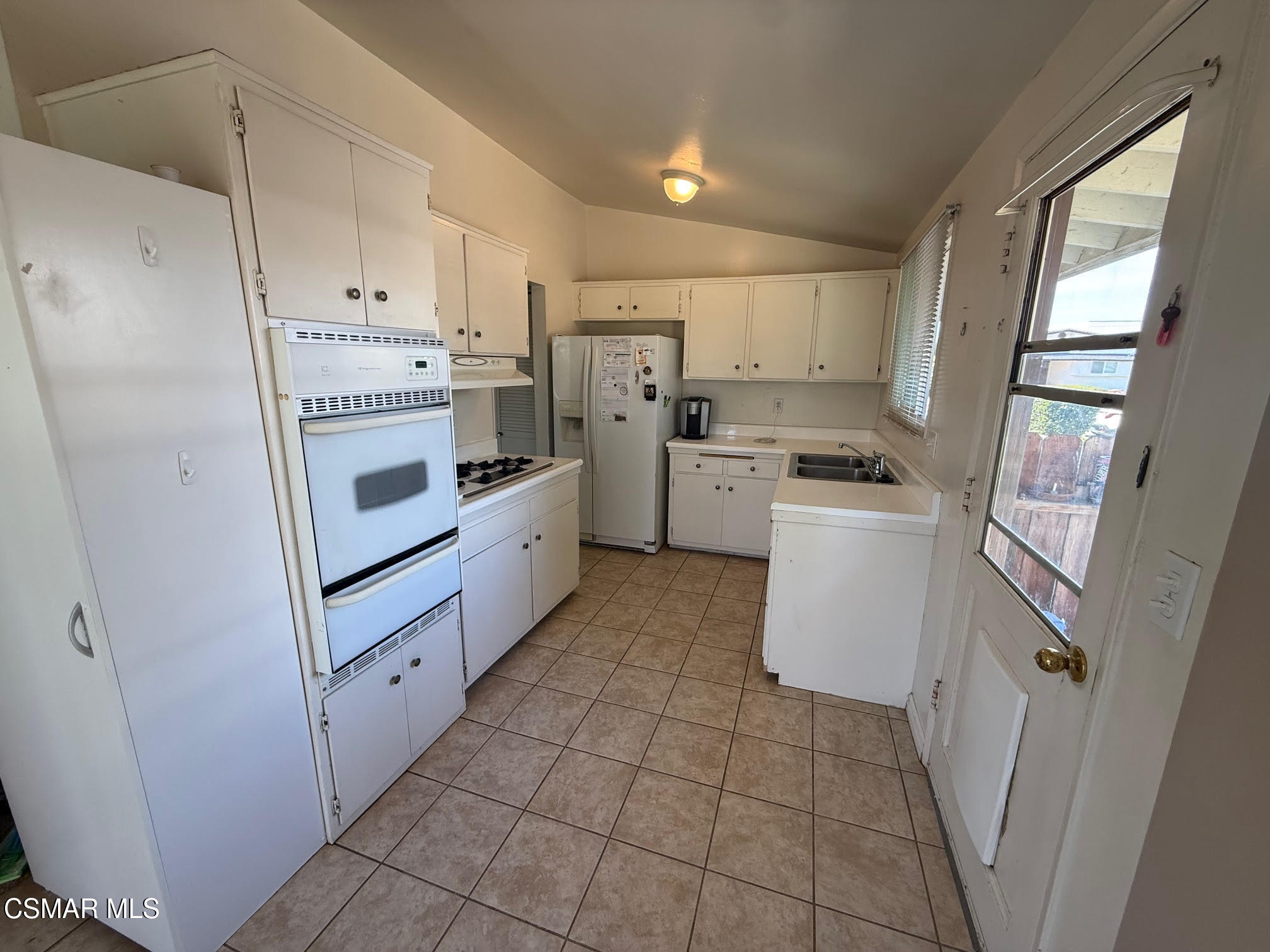 1482 Paul Street Simi Valley, CA 93065 - Photo 5 of 12 a kitchen with white cabinets and white appliances