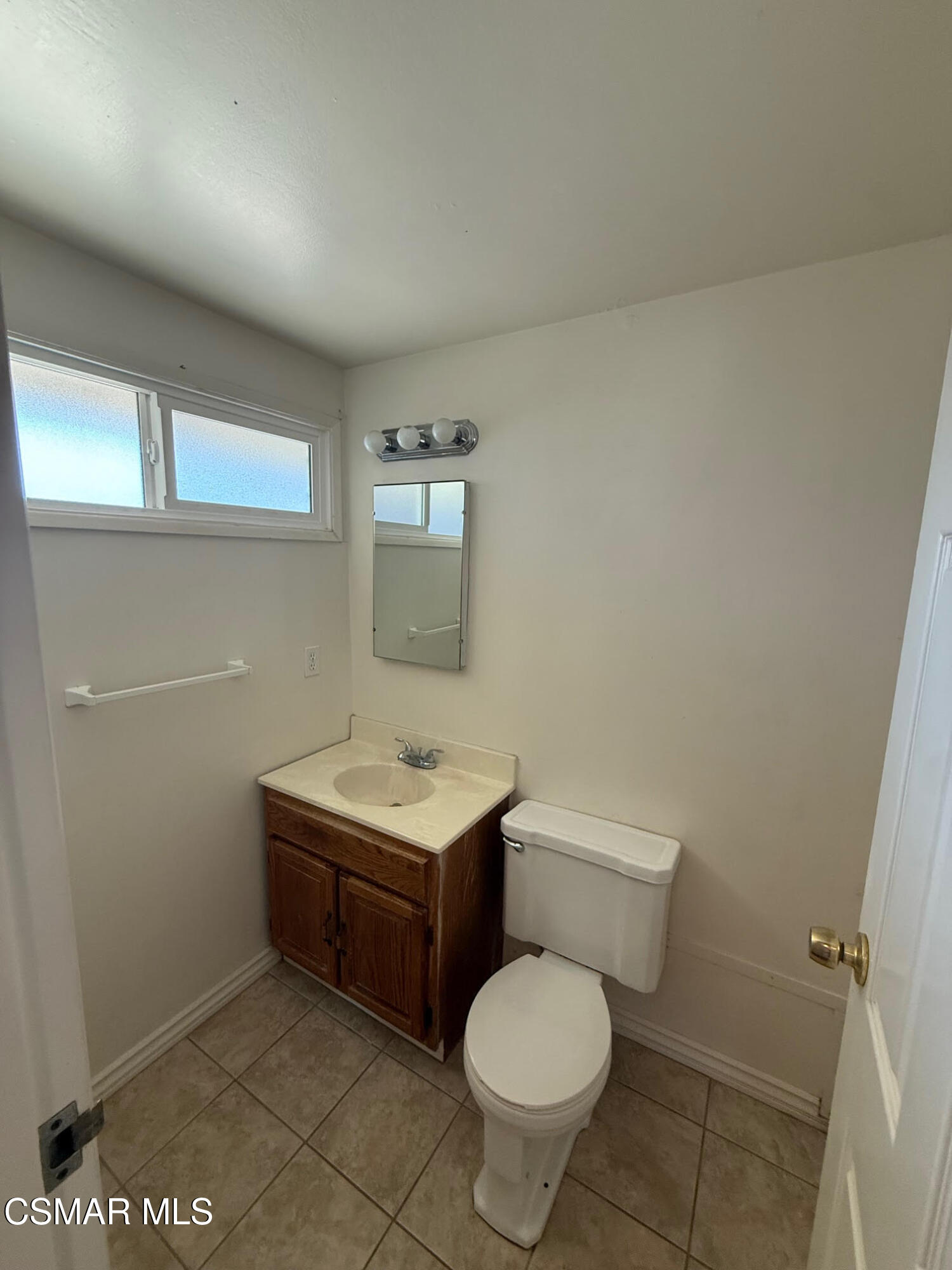 1482 Paul Street Simi Valley, CA 93065 - Photo 8 of 12 a bathroom with a toilet a sink and mirror
