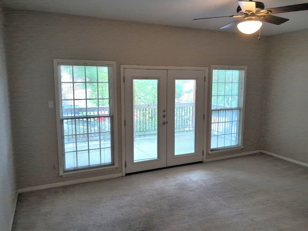 3200 Duval Street, Unit 102 Austin, TX 78705 - Photo 12 of 20 an empty room with windows and chandelier