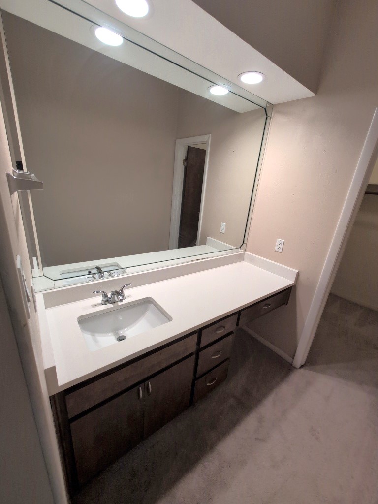 3200 Duval Street, Unit 102 Austin, TX 78705 - Photo 13 of 20 a bathroom with a sink and a mirror