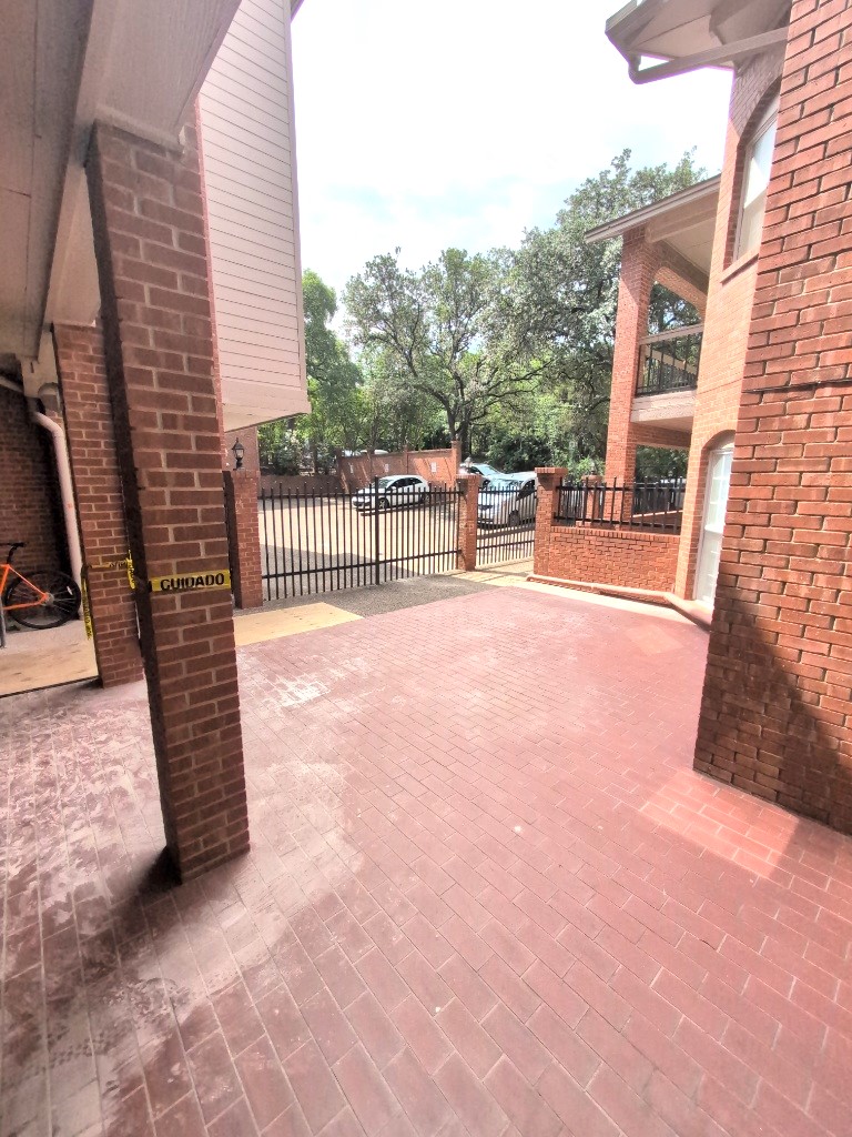 3200 Duval Street, Unit 102 Austin, TX 78705 - Photo 3 of 20 a view of a patio with a table and chairs and wooden fence