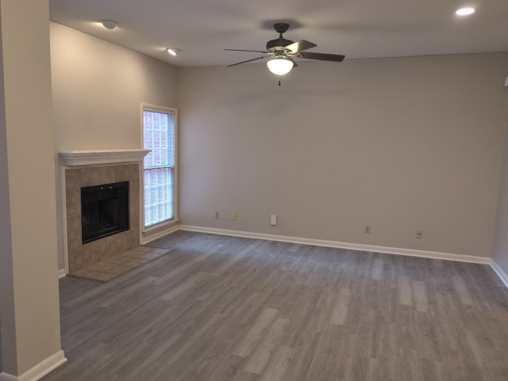 3200 Duval Street, Unit 102 Austin, TX 78705 - Photo 5 of 20 Unfurnished living room featuring dark wood finished floors, ceiling fan, baseboards, a fireplace, and recessed lighting