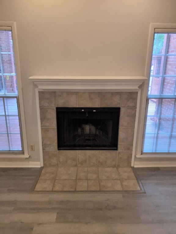 3200 Duval Street, Unit 102 Austin, TX 78705 - Photo 6 of 20 a living room with a fireplace and windows