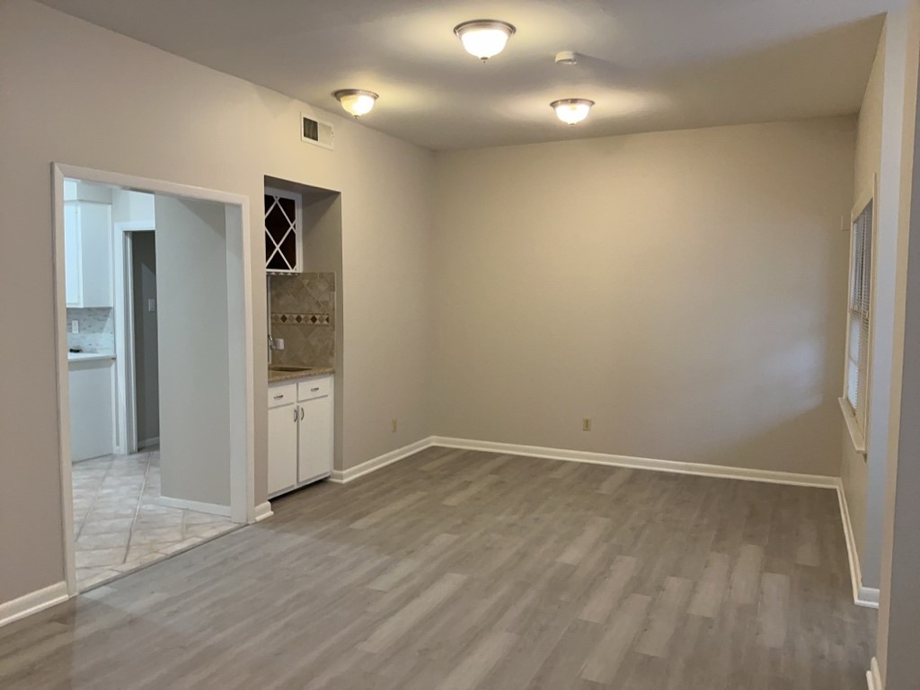 3200 Duval Street, Unit 102 Austin, TX 78705 - Photo 7 of 20 an empty room with wooden floor and entrance