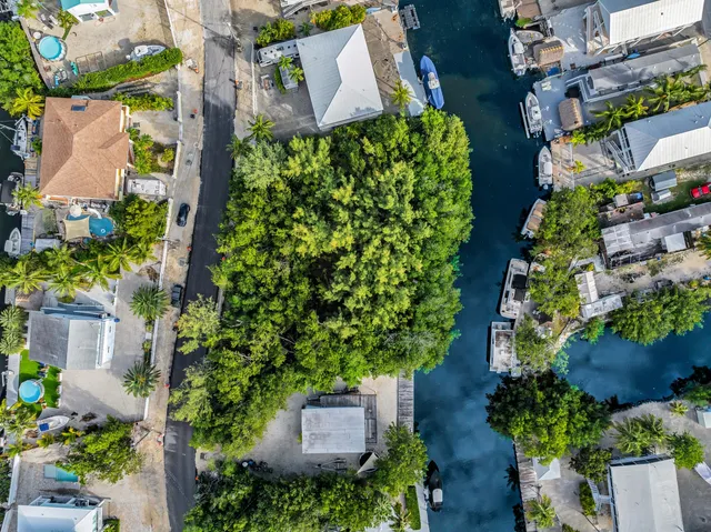 an aerial view of a house with a yard and garden