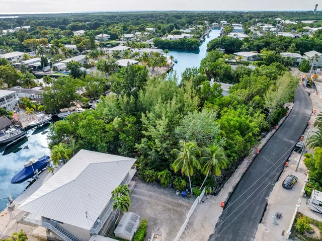 an aerial view of a house with yard
