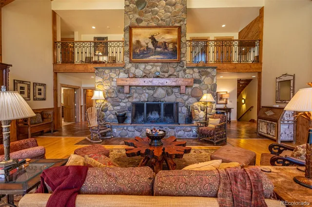 a living room with fireplace furniture and a fireplace
