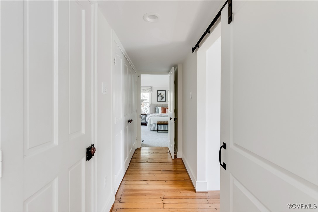 603 Manakin Road Manakin-Sabot, VA 23103 - Photo 20 of 48 Corridor with a barn door and light wood-style flo