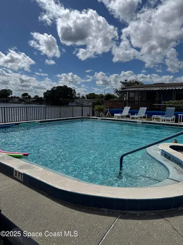 a view of swimming pool with sitting area