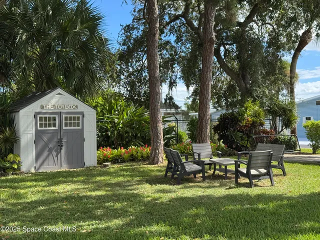 a view of a park with bench and a tree