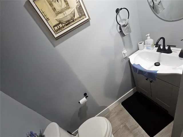 a white toilet sitting next to a bathroom sink