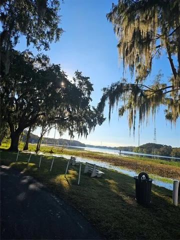 a view of a lake with a table and chairs
