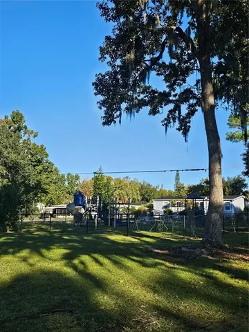 a view of house with swimming pool outdoor seating
