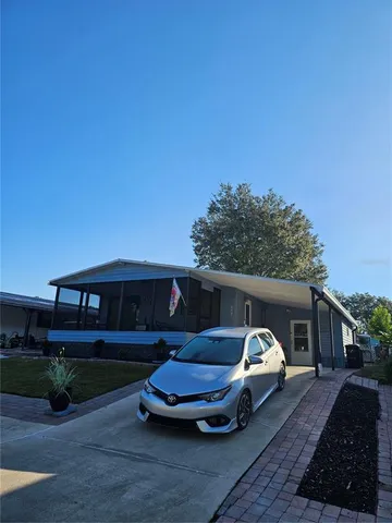 an aerial view of a house with garden space and lake view