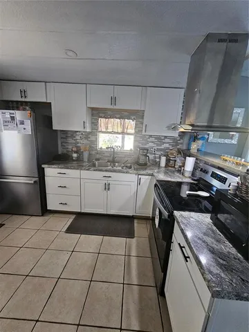 a kitchen with a stove a sink and a refrigerator