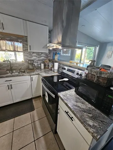 a kitchen with a sink stove and cabinets