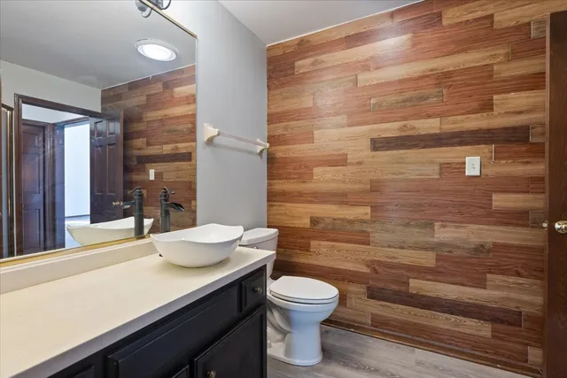 a bathroom with a toilet a sink and mirror