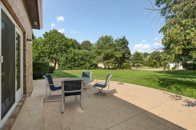 a backyard of a house with outdoor seating