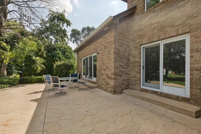 a view of backyard with outdoor seating and plants