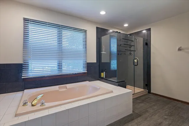 a bathroom with a bathtub and a shower
