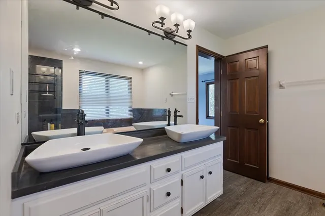 a bathroom with a double vanity sink and mirror