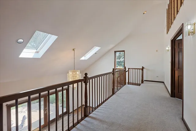 a view of an empty room with a fireplace and a window