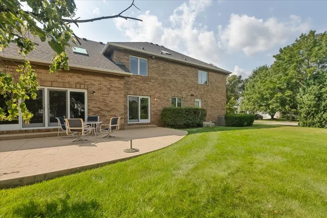a view of a patio with a table and chairs under an umbrella
