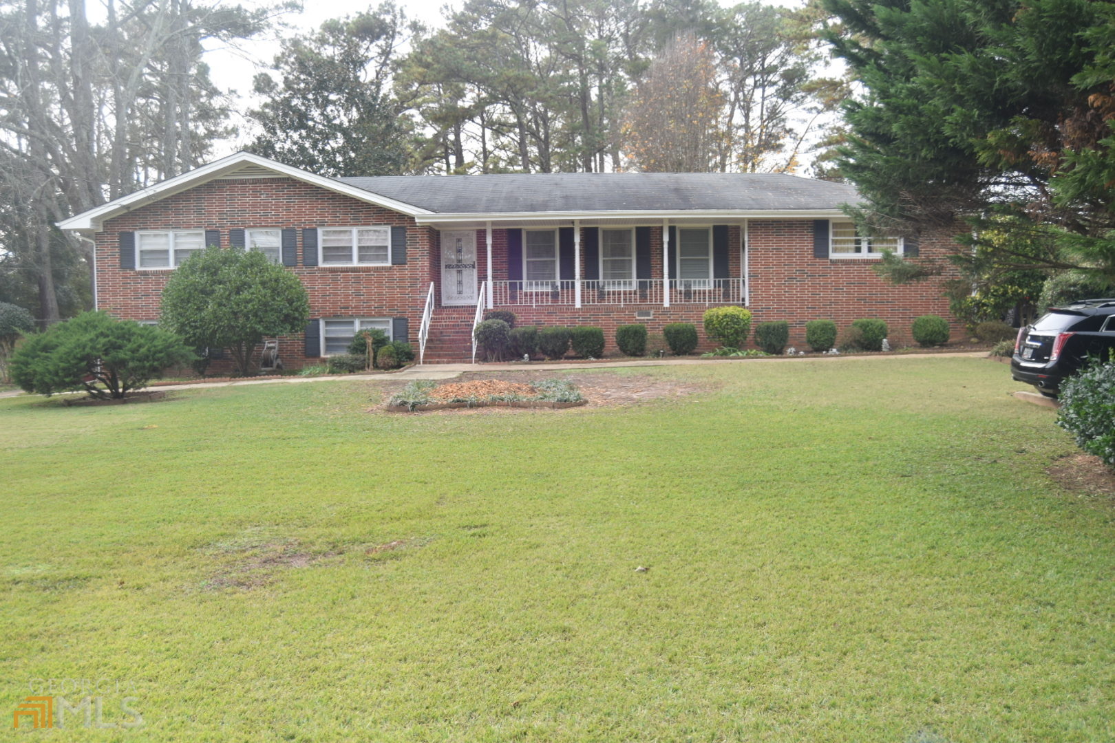 3205 Kelley Chapel Road Decatur, GA 30034 - Photo 1 of 1 a front view of a house with a garden and trees