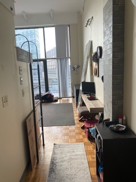 61 Brookline Avenue, Unit 419 Boston, MA 02215 - Photo 3 of 9 a living room with furniture and a window