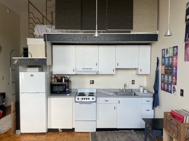 61 Brookline Avenue, Unit 419 Boston, MA 02215 - Photo 4 of 9 a kitchen with a refrigerator and cabinets