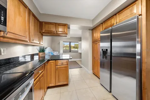 a kitchen with stainless steel appliances granite countertop a refrigerator and a stove