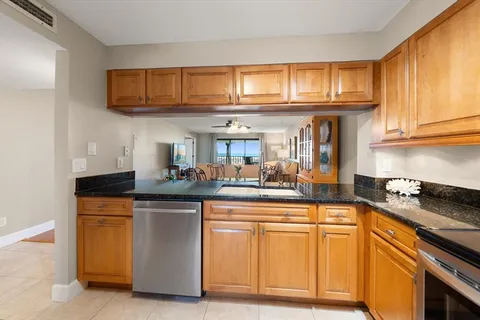 a kitchen with stainless steel appliances granite countertop a stove and a sink