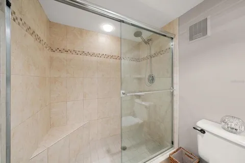 a bathroom with a shower and toilet