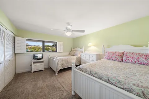 a bedroom with a bed and a night stand