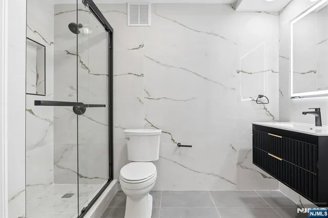 a bathroom with a toilet sink and shower