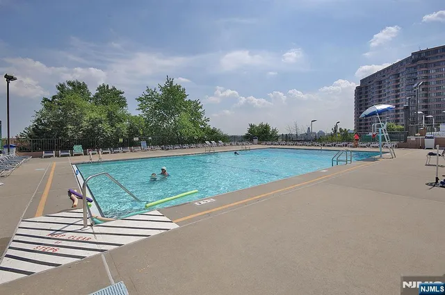 a view of a swimming pool and a yard