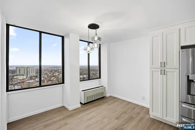 a view of a room with wooden floor and windows