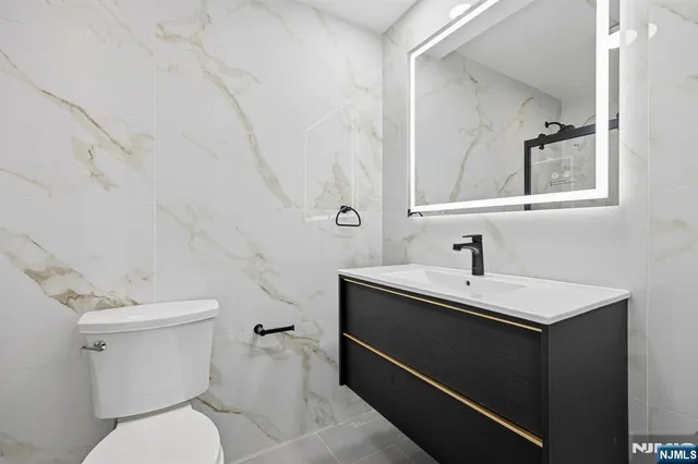 a bathroom with a toilet sink and mirror