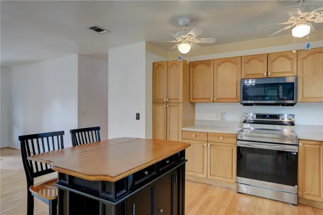 a kitchen that has a cabinets and a stove top oven