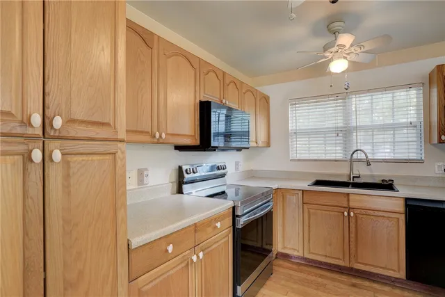 a kitchen with stainless steel appliances a sink stove and microwave