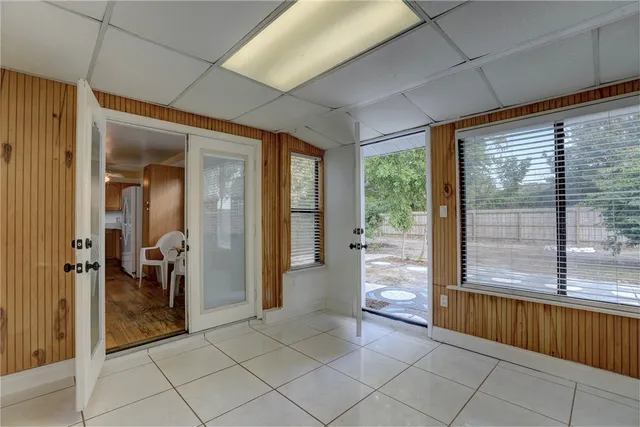 a view of empty room with wooden floor and windows