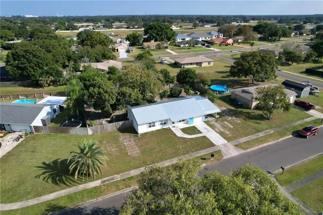 an aerial view of a house with a yard