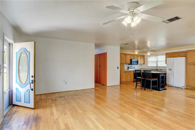 a view of a room with furniture and wooden floor